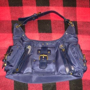 Dark blue handbag with many zippers and pockets